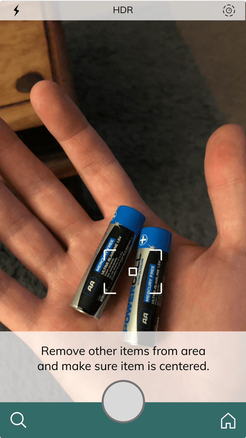 Camera iteration with a framing guide over AA batteries held in a hand